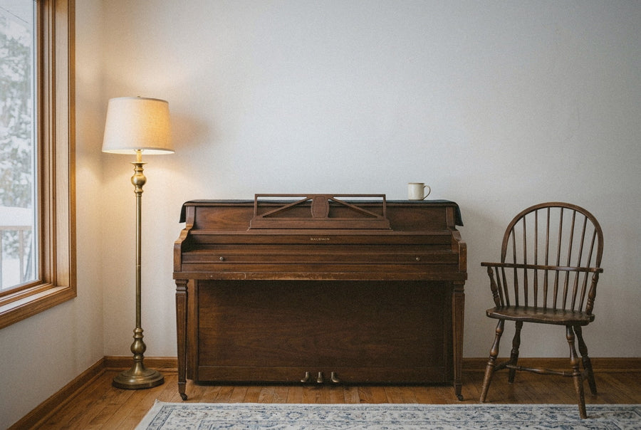 A quiet empty wall above an upright piano in a North American home on a mid-January morning