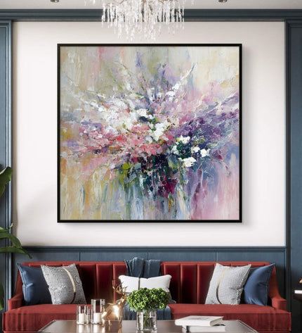 Living room with a red sofa, abstract painting, and chandelier.