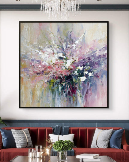 Living room with a red sofa, abstract painting, and chandelier.