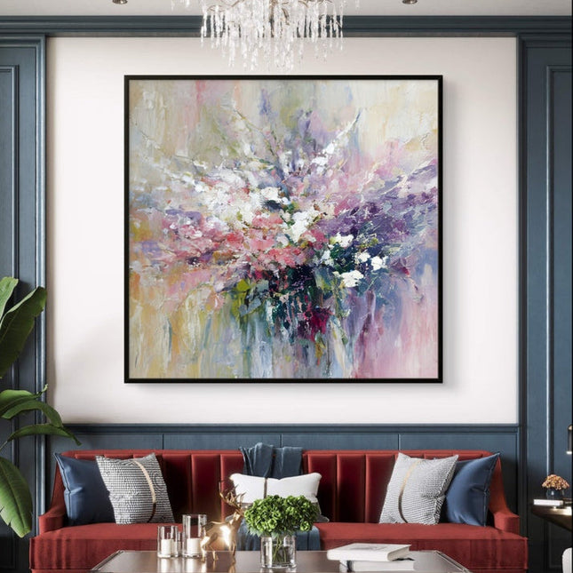 Living room with a red sofa, abstract painting, and chandelier.