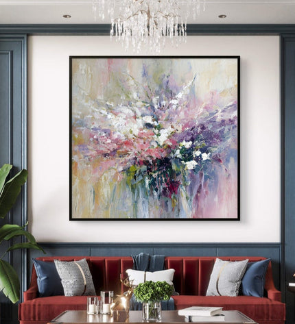 Living room with a red sofa, abstract painting, and chandelier.