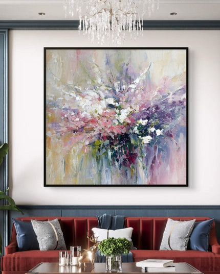 Living room with a red sofa, abstract painting, and chandelier.