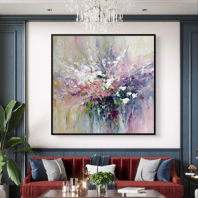 Living room with a red sofa, abstract painting, and chandelier.