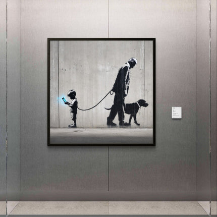 Framed artwork of a man and child with a dog on a leash, displayed on a wall.