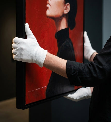 Art handler presenting Crimson Reverie large-format original painting