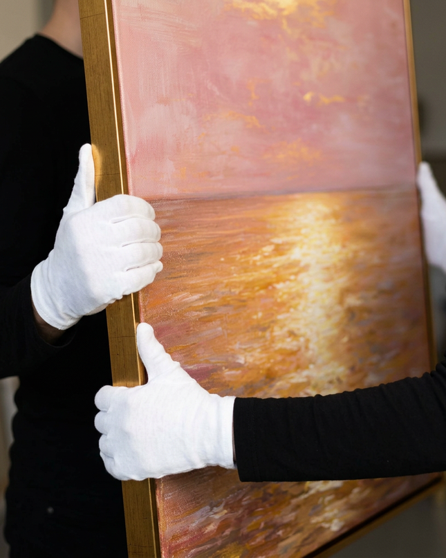 Art handler presenting Golden Horizon large-format original painting