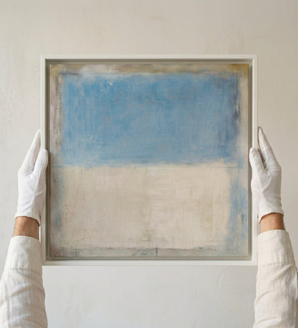 Gallerist presenting Sea & Sand painting with white gloves