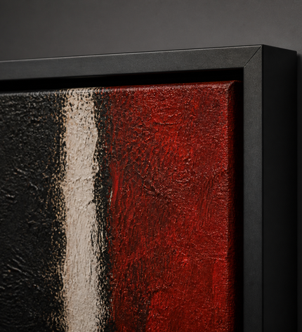 Crimson Divide — close-up showing the matte black metal frame corner